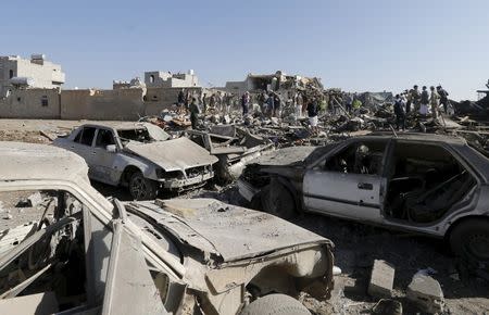 People search for survivors under the rubble of houses destroyed by an air strike near Sanaa Airport March 26, 2015. REUTERS/Khaled Abdullah