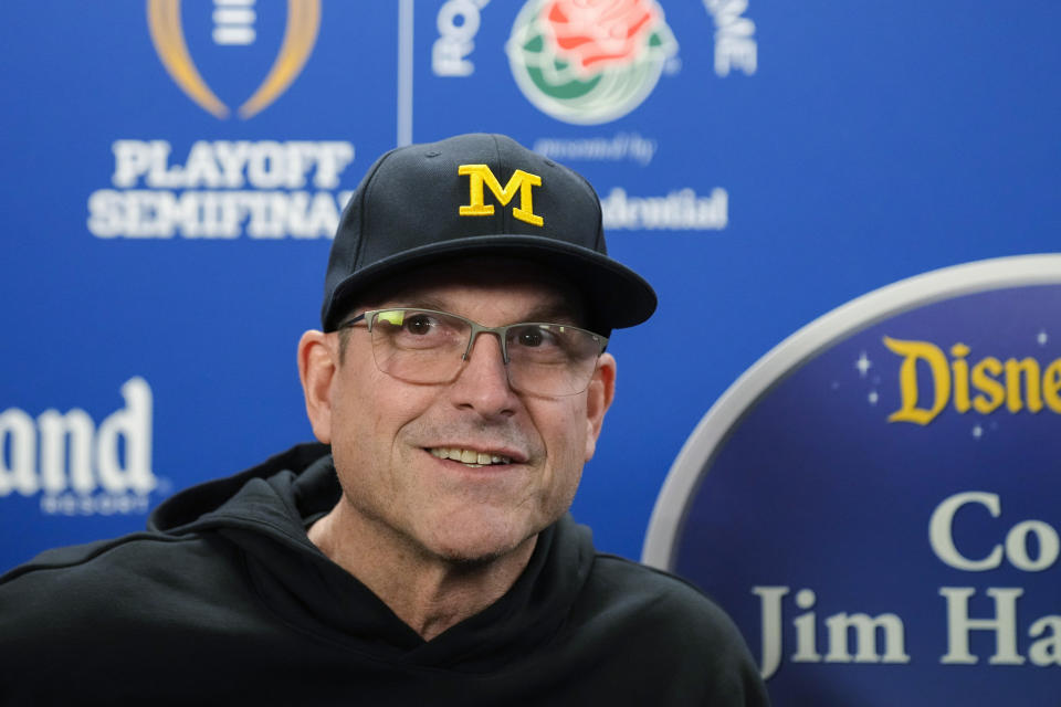 Michigan coach Jim Harbaugh fields speaks to reporters during a welcome event for the team at Disneyland on Wednesday, Dec. 27, 2023, in Anaheim, Calif. Michigan is scheduled to play against Alabama on New Year's Day in the Rose Bowl, a semifinal in the College Football Playoff. (AP Photo/Ryan Sun)