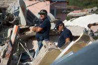 <p>Rescuers dig through the rubble during a search for two missing children on Aon Aug. 22, 2017 in Casamicciola Terme, Italy. (Photo: Ivan Romano/Getty Images) </p>