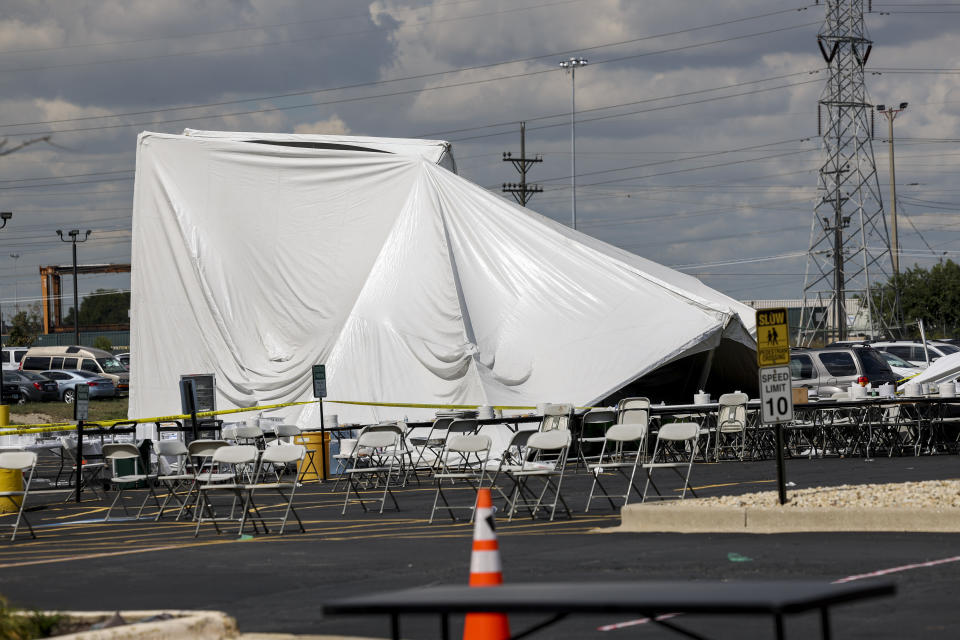 A collapsed tent sits in a parking lot in the 5600 block of West 73rd Street Thursday, Sept. 14, 2023, in Bedford Park, Chicago. Police say a number of people were injured. (Armando L. Sanchez/Chicago Tribune via AP)