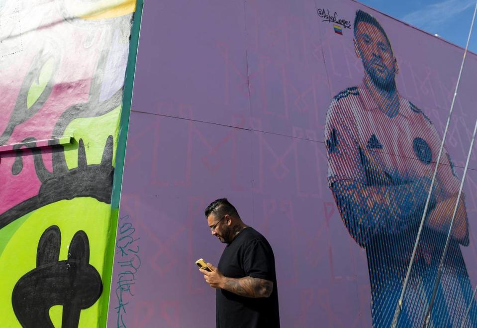 A man walks past a Lionel Messi mural located near the intersection of Northwest 2nd Avenue and 23rd Street on Wednesday, July 12, 2023, in Miami, Fla.
