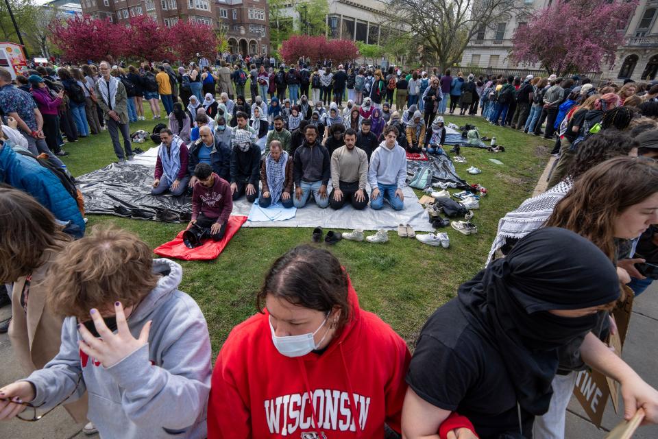 Muslims take time to pray during a day of protest against the Israel-Gaza war at the University of Wisconsin-Madison.