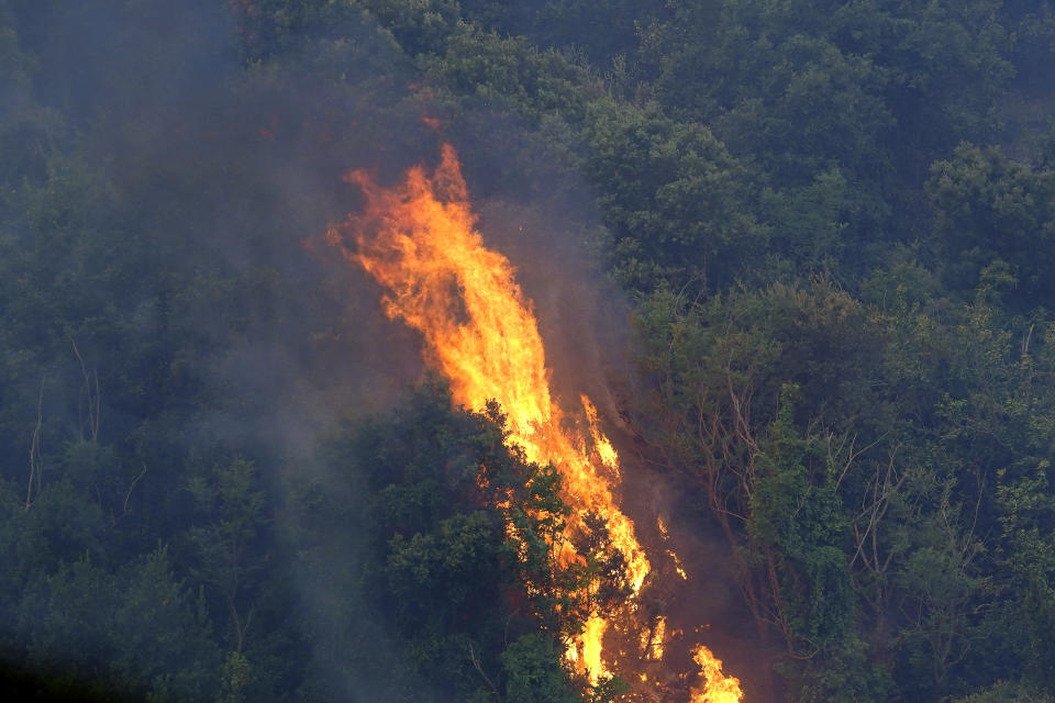 Fires rage through the countryside in Cuglieri, near Oristano, Sardinia, Italy, early Sunday, July 25, 2021. Hundreds of people were evacuated from their homes in many small towns in the province of Oristano, Sardinia, after raging fires burst in the areas of Montiferru and Bonarcado. (Alessandro Tocco/LaPresse via AP)