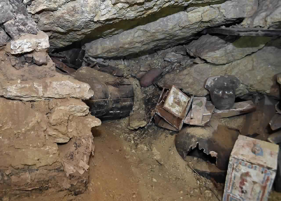 This undated photo provided by the Egyptian Ministry of Tourism and Antiquities shows a trove of ancient coffins and artifacts that Egyptian archaeologists unearthed in a vast necropolis south of Cairo, authorities said Monday, Oct. 19, 2020, in Saqqara, south of Cairo, Egypt. The Tourism and Antiquities Ministry said in a statement that archaeologists found a “large number” of colorful, sealed sarcophagi buried more than 2,500 years ago. (Ministry of Tourism and Antiquities via AP)