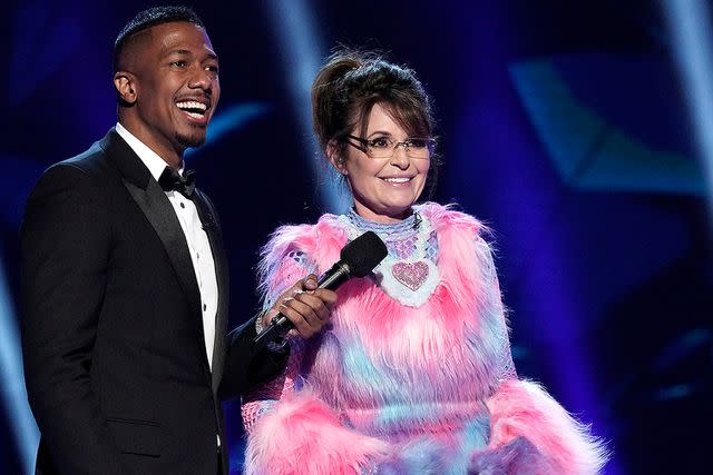 <p>FOX via Getty </p> Host Nick Cannon and Sarah Palin on 'The Masked Singer'