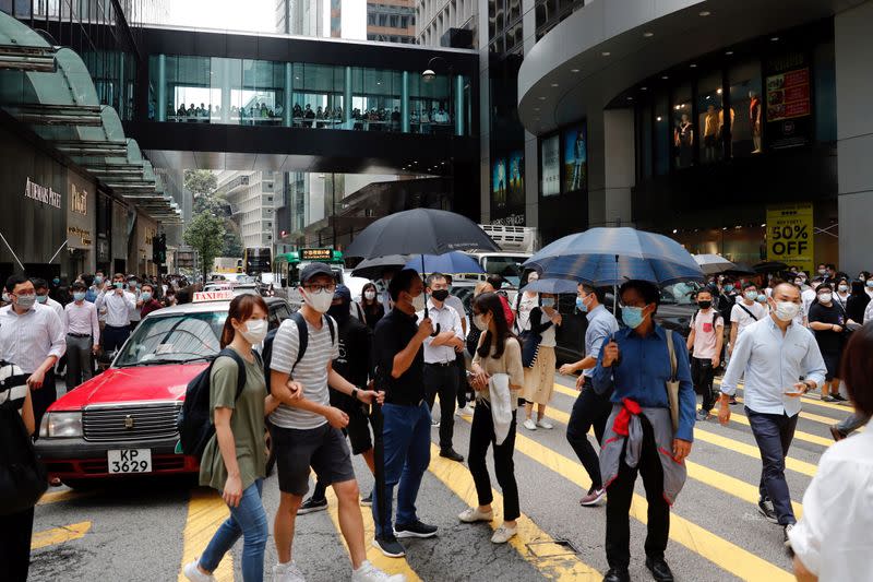 Anti-government demonstrators take part in a protest during a lunch time in Hong Kong