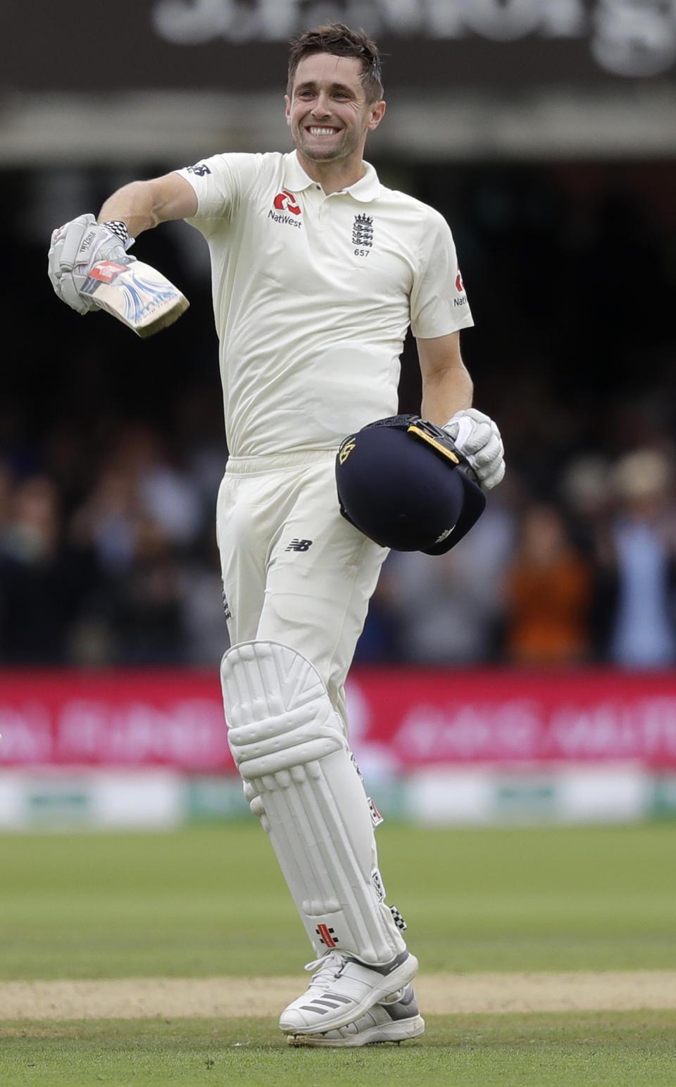 England's Chris Woakes celebrates scoring a century during the third day of the second test match between England and India at Lord's cricket ground in London, Saturday, Aug. 11, 2018. (AP Photo/Kirsty Wigglesworth)