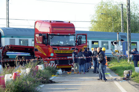 Italian police officers inspect the place where a train plowed into a truck last night in Caluso near Turin, Italy, May 24, 2018. REUTERS/Massimo Pinca