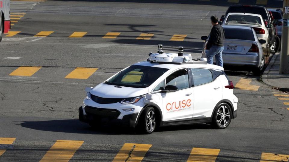 A Cruise car with cameras on its roof on the street in San Francisco