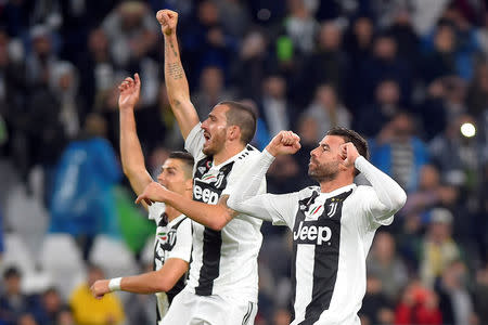 Soccer Football - Serie A - Juventus v Cagliari Calcio - Allianz Stadium, Turin, Italy - November 3, 2018 Juventus' Cristiano Ronaldo, Leonardo Bonucci and Andrea Barzagli celebrate after the match REUTERS/Massimo Pinca