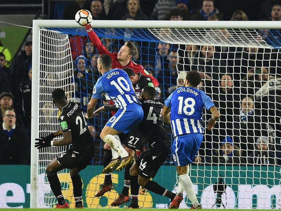 Wayne Hennessey asserts himself to punch clear a Brighton delivery (Getty)