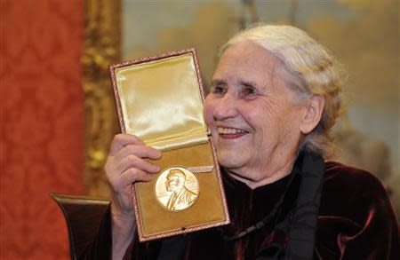 British novelist Doris Lessing is seen smiling as she poses with her Nobel Prize for Literature at the Wallace Collection in London in this January 30, 2008 file photograph. Lessing has died her publisher said on Sunday. REUTERS/Toby Melville/Files