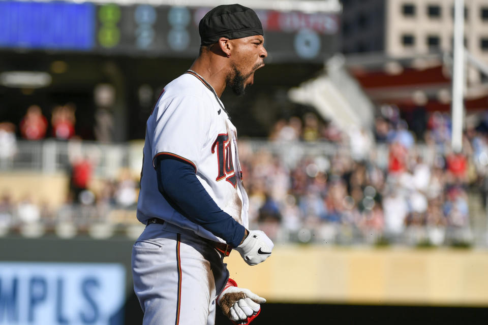 Minnesota Twins' Byron Buxton shouts in celebration after hitting an RBI-triple against Colorado Rockies pitcher Antonio Senzatela during the first inning of a baseball game, Saturday, June 25, 2022, in Minneapolis. Luis Arraez scored. (AP Photo/Craig Lassig)