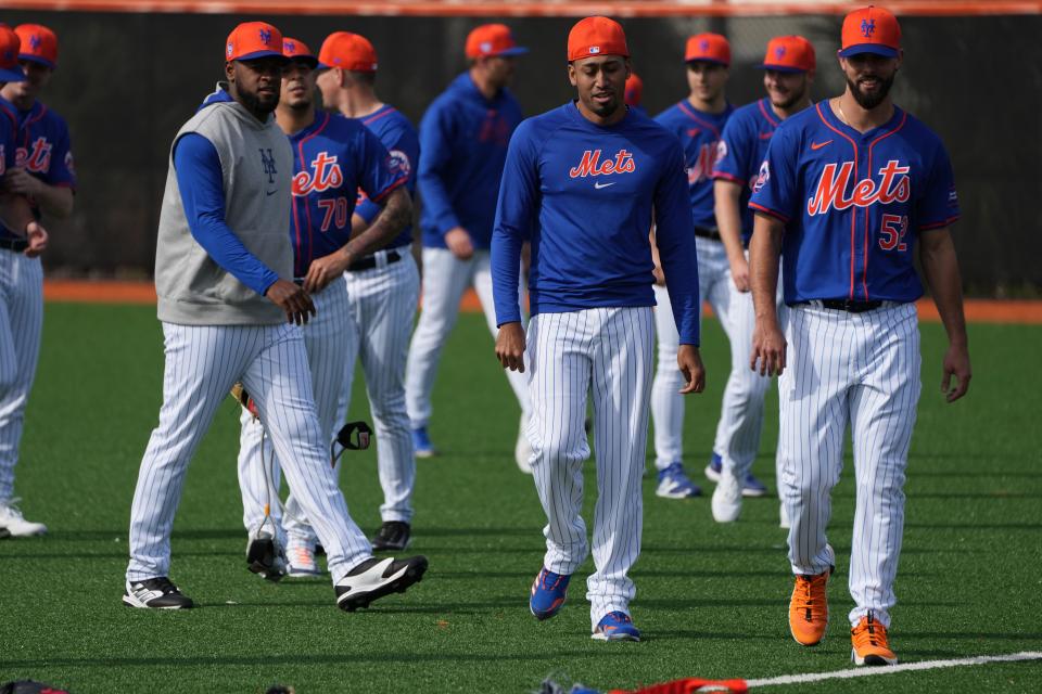 Feb 14, 2024; Port St. Lucie, FL, USA; New York Mets relief pitcher Edwin Diaz, center, and the pitching staff warm-up during workouts at spring training. Mandatory Credit: Jim Rassol-USA TODAY Sports