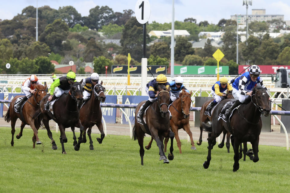 Jockey Mark Zahra rides Gold Trip, right, lead while approaching the finish to win the Melbourne Cup horse race in Melbourne, Australia, Tuesday, Nov. 1, 2022. (AP Photo/Asanka Brendon Ratnayake)