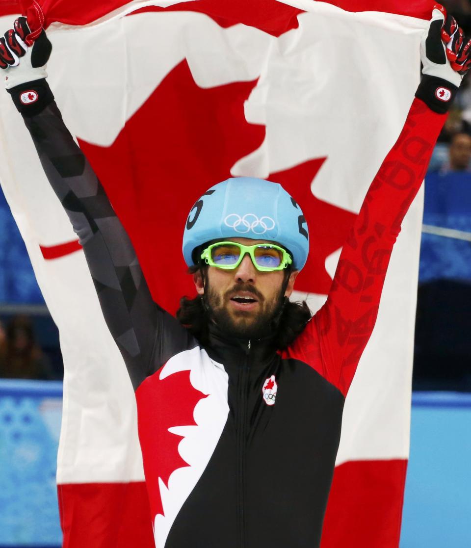 Canada's Charles Hamelin celebrates winning the men's 1,500 metres short track speed skating race finals at the Iceberg Skating Palace during the 2014 Sochi Winter Olympics February 10, 2014. REUTERS/David Gray (RUSSIA - Tags: SPORT SPEED SKATING OLYMPICS)