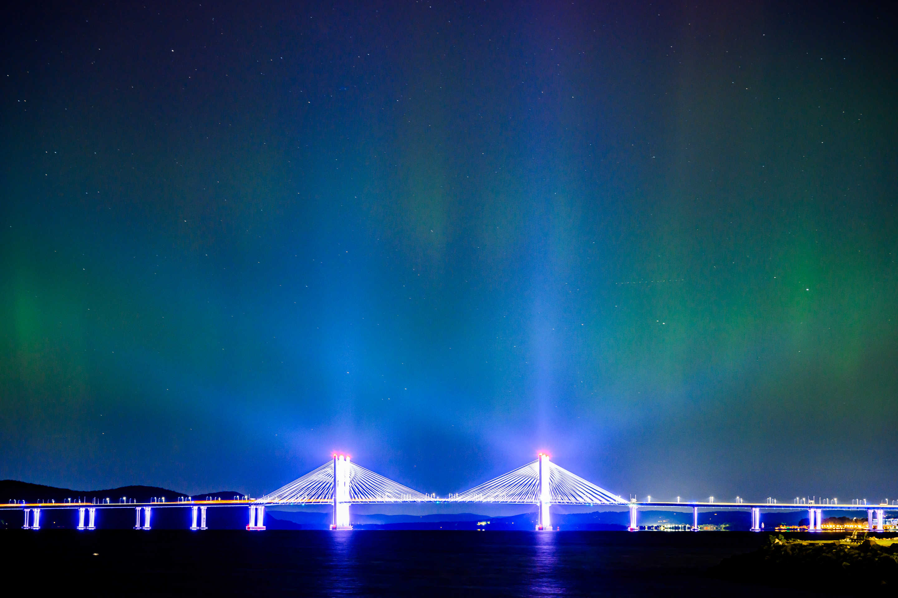 The Northern Lights or Aurora Borealis are visible over the Tappan Zee or Governor Mario M. Cuomo Bridge Bridge on October 11, 2024 near New York City. (Roy Rochlin/Getty Images)