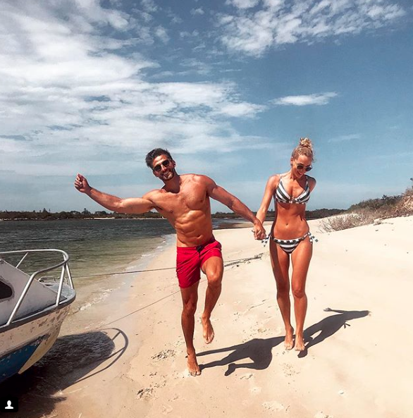 Anna Heinrich and Tim Robards skip down the beach while on holidays on Sunday. Source: Instagram