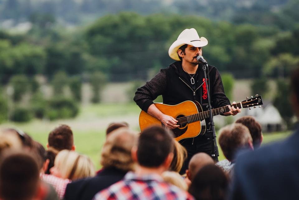 <a href="https://people.com/tag/brad-paisley/" rel="nofollow noopener" target="_blank" data-ylk="slk:Brad Paisley;elm:context_link;itc:0;sec:content-canvas" class="link ">Brad Paisley</a> performs at the weekend's opening reception held at Regusci Winery on May 14.