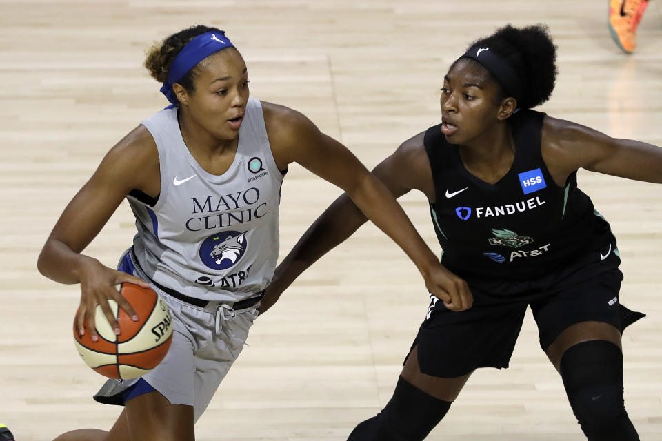 Minnesota Lynx forward Napheesa Collier (24, left) drives around New York Liberty guard Jocelyn Willoughby during the first half of a WNBA basketball game Wednesday, Aug. 5, 2020, in Bradenton, Fla. (AP Photo/Chris O'Meara)