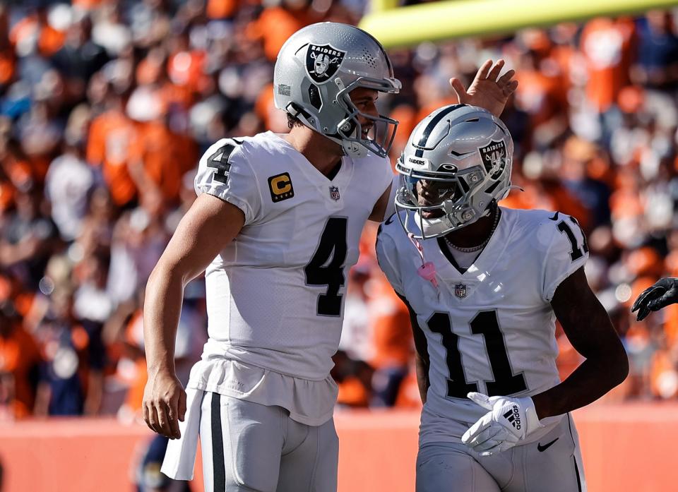 Derek Carr and Henry Ruggs III celebrate after a touchdown in the first quarter against the Denver Broncos.