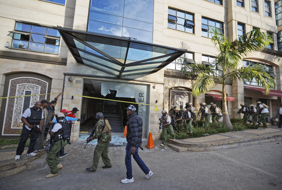 Security forces surround a shattered door in which an unexploded grenade lies at a hotel complex in Nairobi, Kenya, Jan. 15, 2019. (Photo: Ben Curtis/AP)