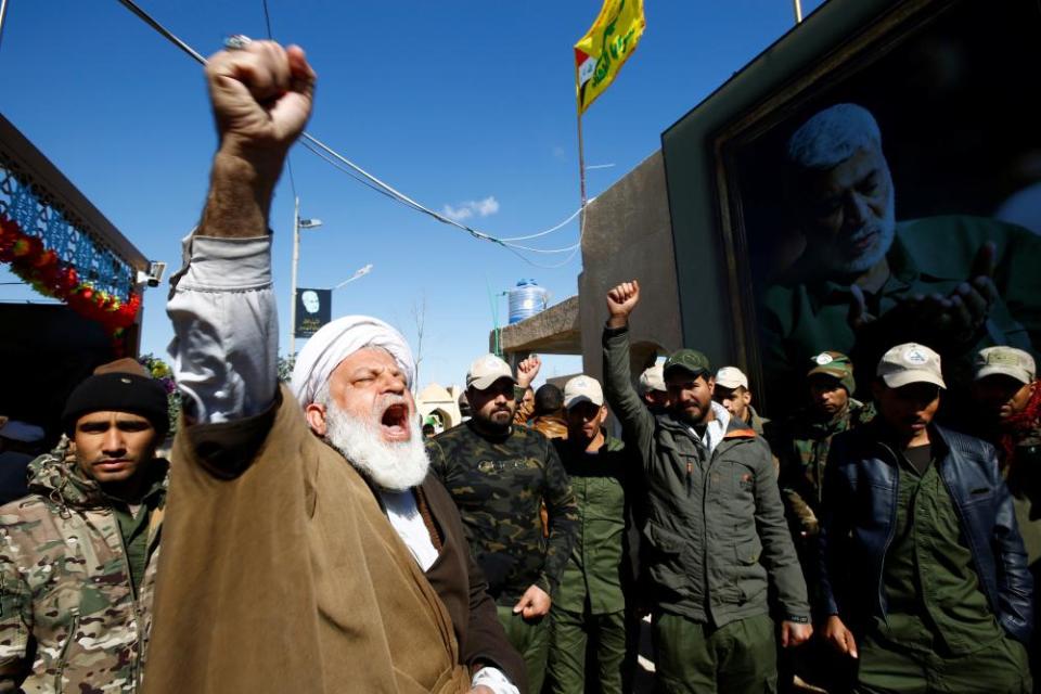 An Iranian cleric pays tribute at the Valley of Peace cemetery in Najaf.