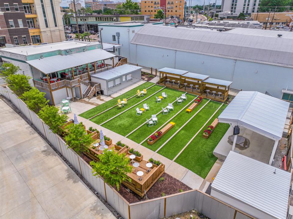 The Yard in Fondren is a gathering space behind the revived historic Capri Theatre, Highball Lanes, and The Pearl Tiki Baras well as directly behind The Station, a vintage gas station-turned indoor-outdoor craft pizza joint and bar.
