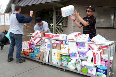 Volunteers stack donated items at a Red Cross relief center in Chico, California, after an evacuation was ordered for communities downstream from the Lake Oroville Dam, in Oroville, California, U.S. February 13, 2017. REUTERS/Beck Diefenbach