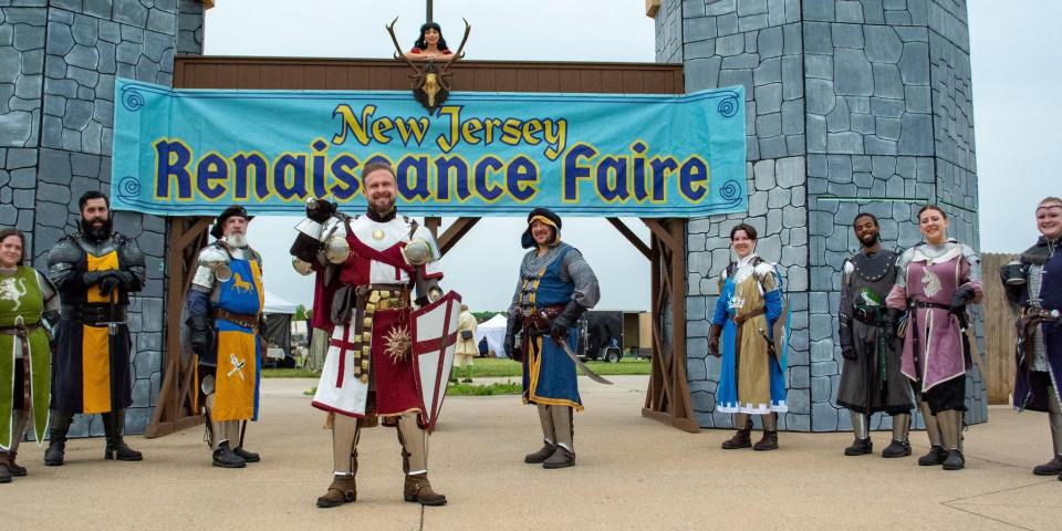 Swords and Stories, which performs theatrical fight shows, poses at the entrance gate to Renaissance Faire.