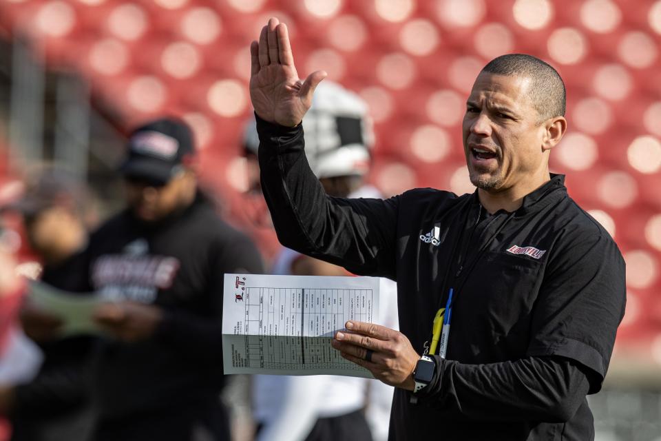 U of L's new offensive coordinator, Lance Taylor, right, calls out plays during U of L's first spring football practice of 2022 on Monday afternoon. Feb. 28, 2022