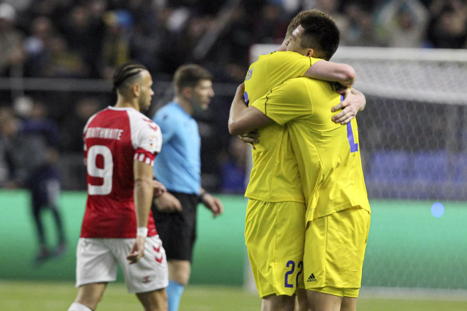 Kazakhstan players embrace following their team victory in the Euro 2024 group H qualifying soccer match between Kazakhstan and Denmark at the Astana Arena stadium in Astana, Kazakhstan, Sunday, March 26, 2023. (AP Photo/Ilyas Omarov)