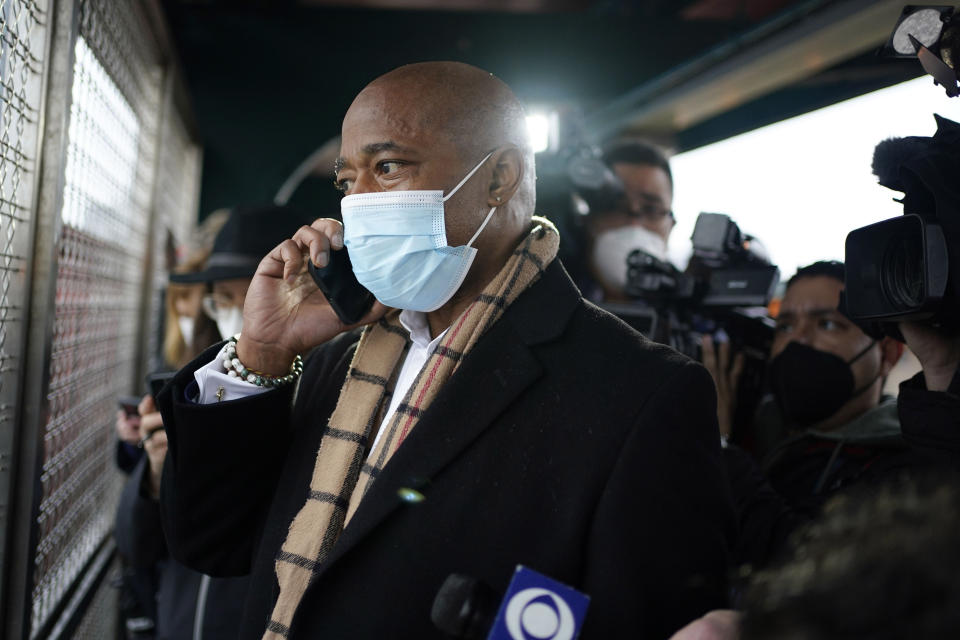 FILE — New York Mayor Eric Adams calls the police while keeping his eye on a fight in the street as he waits for the subway to City Hall, in New York, Jan. 1, 2022. Adams called to report an assault in progress. New York City's new mayor is a hands-on politician and nightlife enthusiast who at times has approached the job like a showman or a therapist, proclaiming the benefits of medication, the glory of vegetables and the "swagger" he says he brings to the city. (AP Photo/Seth Wenig, File)