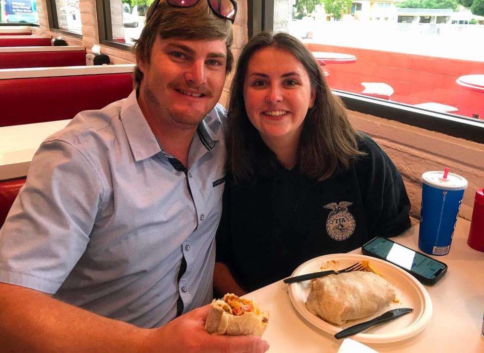 Jordan McNealley and Lorelei Rains dig into their overstuffed breakfast burrito at Frank’s Famous Hot Dogs on Friday, June 2, 2023. They were getting married the next day in Creston.