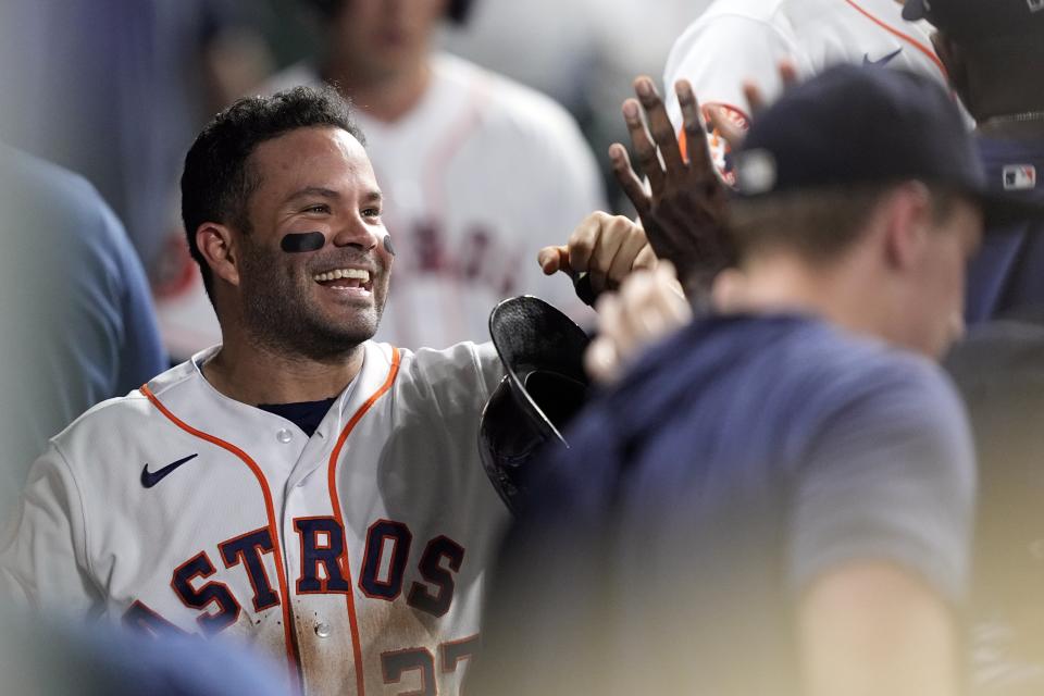 Houston Astros' Jose Altuve celebrates in the dugout after scoring a run against the Washington Nationals during the seventh inning of a baseball game Tuesday, June 13, 2023, in Houston. The run was Altuve's 1,000th of his career. (AP Photo/David J. Phillip)