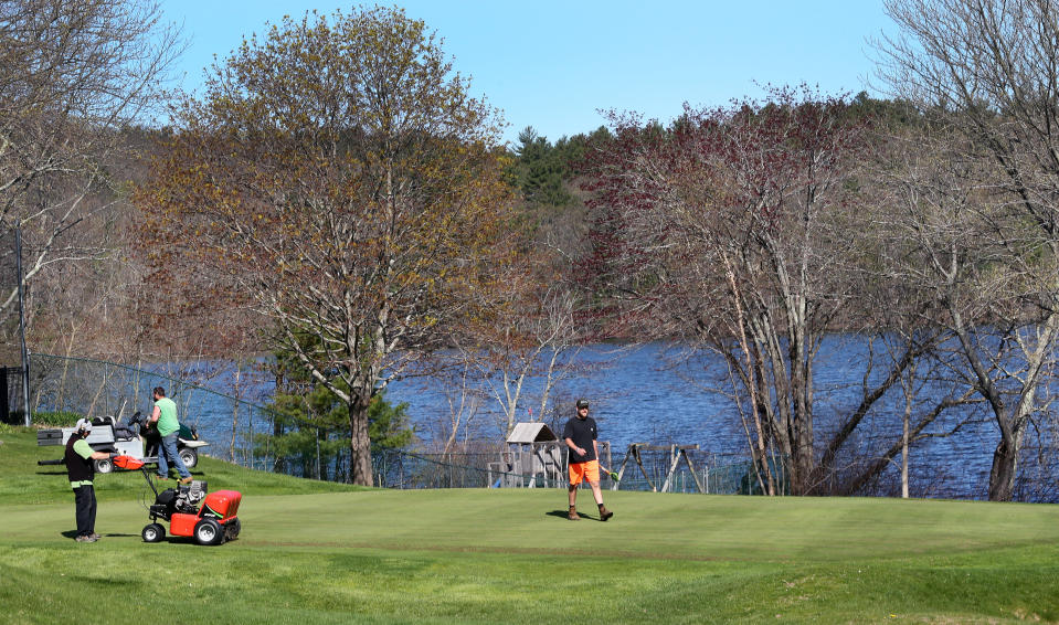 NORTH ANDOVER, MA - MAY 4: Although all golf courses in Massachusetts are still ordered to stay closed by governor Charlie Baker, workers at the North Andover Country Club in North Andover, MA work on the grass on May 4, 2020, getting the course ready for when they eventually are allowed to re-open. (Photo by Jim Davis/The Boston Globe via Getty Images)