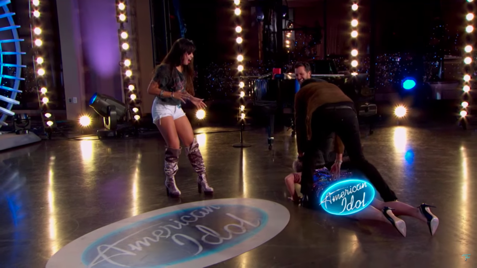 It took a few attempts, and some help from her knights in shining armour, Luke and Lionel, to help but Katy eventually got back on her feet. Source: YouTube / American Idol