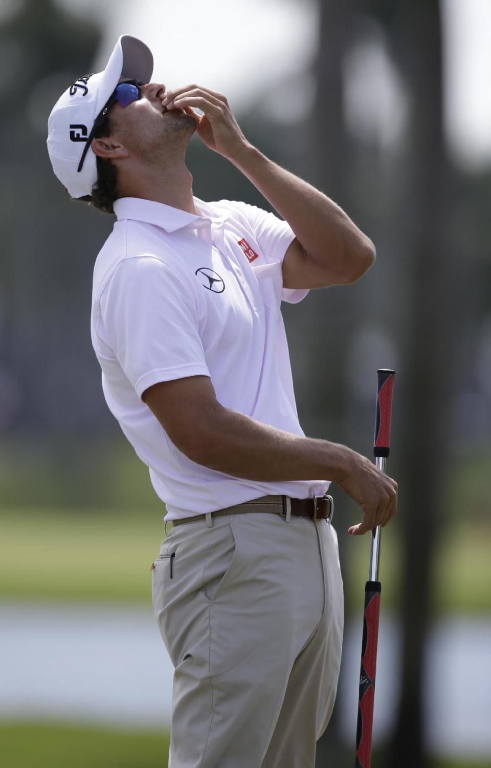 Adam Scott of Australia grimaces as his ball misses a par putt on the 10th hole during the second round of the Cadillac Championship golf tournament Friday, March 7, 2014, in Doral, Fla. (AP Photo/Wilfredo Lee)