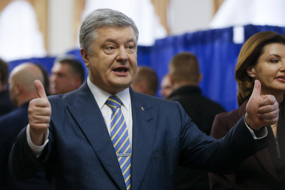 Ukrainian President Petro Poroshenko gestures as he arrives at a polling station during the presidential election in Kiev, Ukraine, Sunday, March 31, 2019. Voters in Ukraine are casting ballots in a presidential election Sunday after a campaign that produced a comedian with no political experience as the front-runner and allegations of voter bribery. (AP Photo/Efrem Lukatsky)