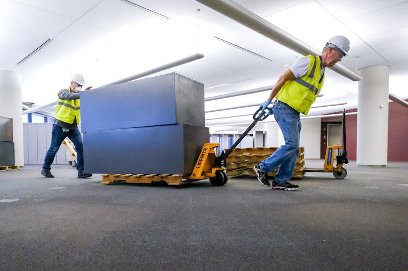 Workers clear furniture from a floor inside the GM Kokomo, Indiana building that General Motors and Ventec Life Systems are converting into use for the production of Ventec ventilators in response to the spread of the coronavirus disease