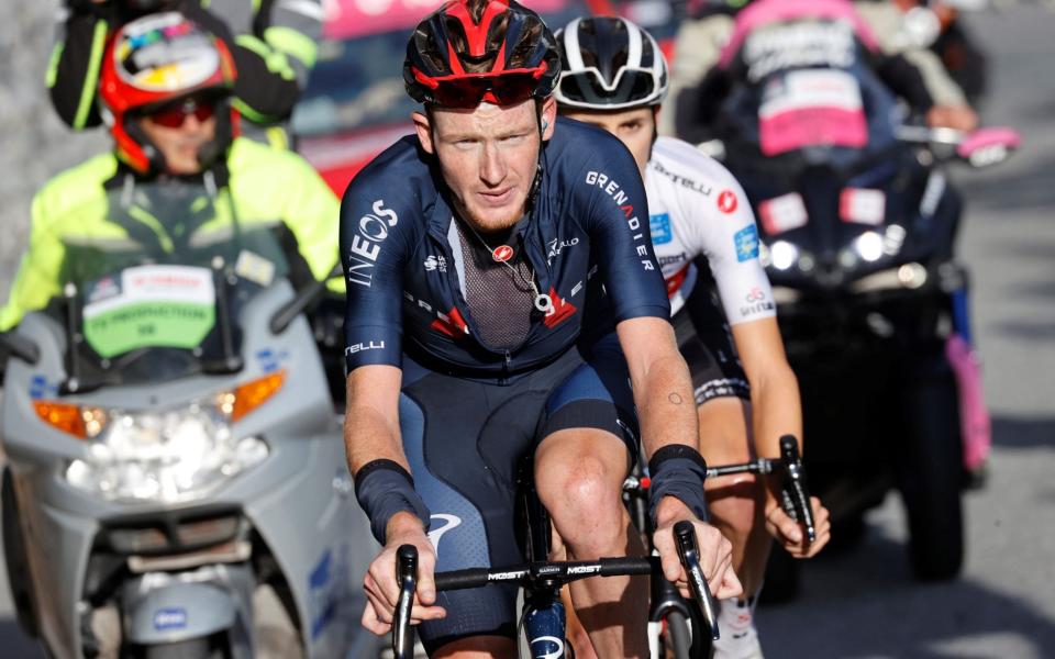 Team Ineos rider Great Britain's Tao Geoghegan Hart (C) rides uphill at Passo dello Stelvio - LUCA BETTINI/AFP via Getty Images