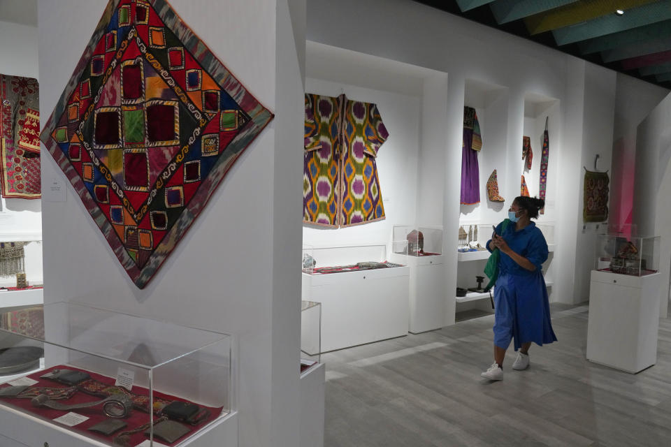 Tourist Chamali Smith from St. Helens, England, walks through the Afghanistan pavilion at Expo 2020 in Dubai, United Arab Emirates, Thursday, Oct. 7, 2021. A Vienna-based antique dealer has opened the Afghanistan pavilion at Expo 2020 about a week after the world's fair began without it amid the turmoil facing his country following the Taliban takeover there. (AP Photo/Jon Gambrell)