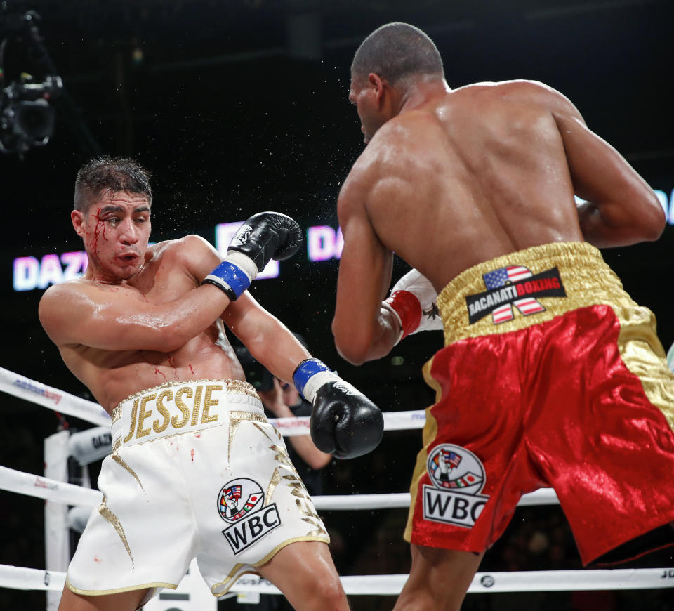 Thomas Dulorme, right, trades punches with Jessie Vargas during the WBC boxing bout Saturday, Oct. 6, 2018, in Chicago. (AP Photo/Kamil Krzaczynski)