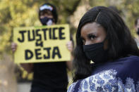 Deja Stallings listens during a news conference outside city hall Thursday, Oct. 8, 2020, in Kansas City, Mo. Protesters have occupied the lawn and plaza in front of city hall more than a week demanding the resignation of police chief Rick Smith and the officer who knelt on Stallings' back while arresting the pregnant woman last week. (AP Photo/Charlie Riedel)