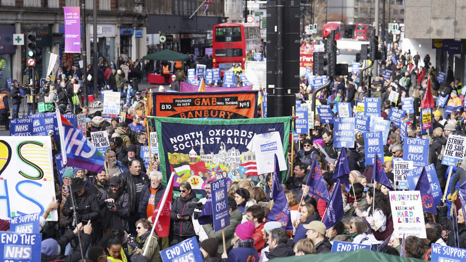 People gather in London, Saturday March 11, 2023, ahead of a Support the Strikes march in solidarity with nurses, junior doctors and other NHS staff following recent strikes over pay and conditions. (James Manning/PA via AP)