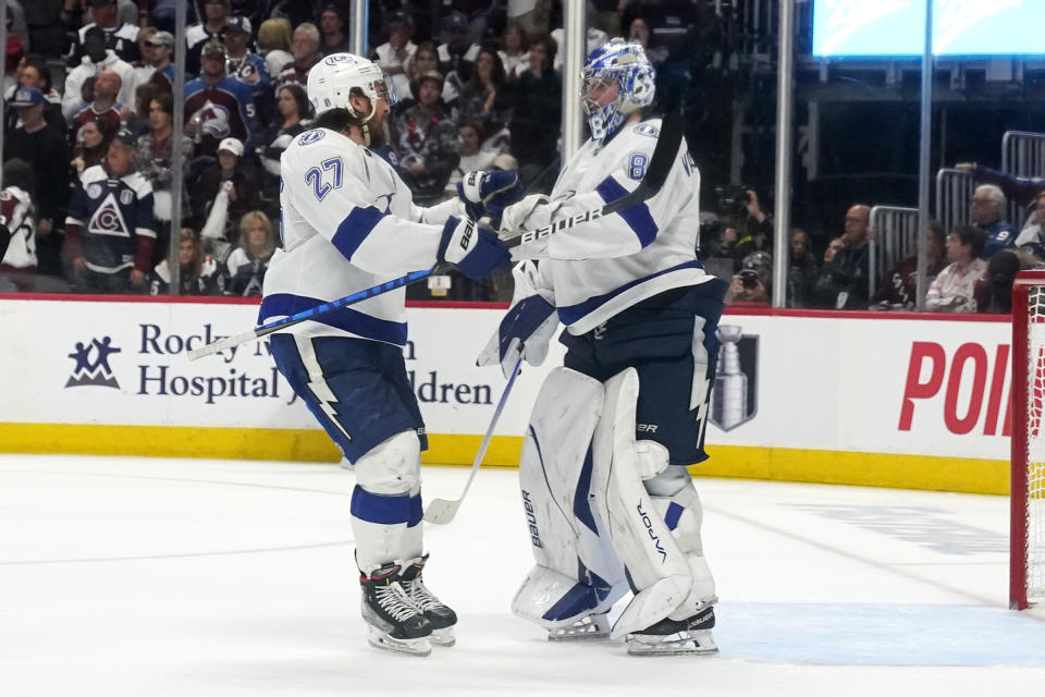 Tampa Bay Lightning's Andrei Vasilevskiy, right, and Ryan McDonagh celebrate the team's 3-2 win against the Colorado Avalanche in Game 5 of the NHL Stanley Cup Final, Friday, June 24, 2022, in Denver. (AP Photo/Jack Dempsey)