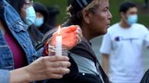 Mourners hold candles at a vigil in Calgary, after the remains of 215 children were found at a former residential school site in B.C. (Terri Trembath/CBC - image credit)