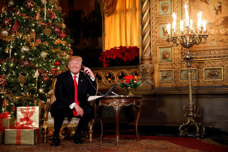 U.S. President Donald Trump participates in NORAD (North American Aerospace Defense Command) Santa Tracker phone calls with children at Mar-a-Lago estate in Palm Beach, Florida, U.S., December 24, 2017. REUTERS/Carlos Barria