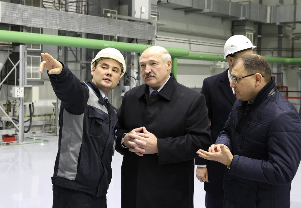 Belarusian President Alexander Lukashenko, centre, attends the first Belarusian Nuclear Power Plant during the plant's power launch event outside the city of Astravets, Belarus, Saturday, Nov. 7, 2020. Alexander Lukashenko on Saturday formally opened the country's first nuclear power plant, a project sharply criticized by neighboring Lithuania. Lukashenko said the launch of the Russian-built and -financed Astravyets plant "will serve as an impetus for attracting the most advanced technologies to the country and innovative directions in science and education." (Maxim Guchek/BelTA Pool Photo via AP)