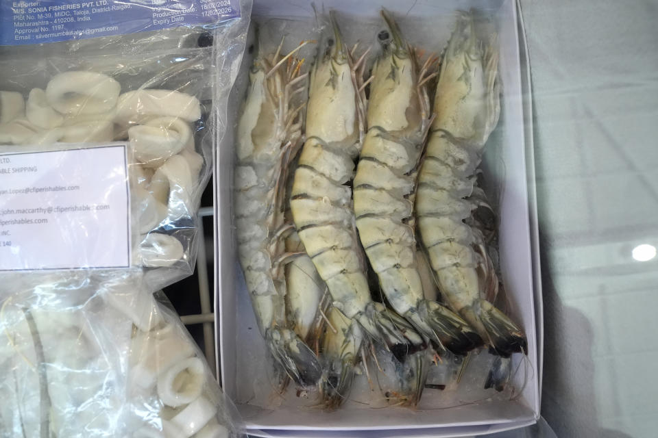 Frozen shrimp, right, is displayed with other seafood in a freezer at India's Marine Products Export Development Authority exhibit booth at the North American Seafood Expo, Monday, March 11, 2024, in Boston. The Marine Products Export Development Authority is an Indian seafood company that exports products to the U.S. (AP Photo/Steven Senne)